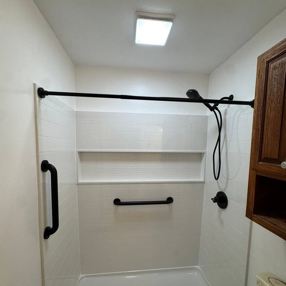 Bright finished bathroom with white vanity and tub
